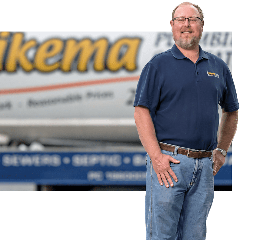 Owner dirk in front of his Feikema septic truck with logo 