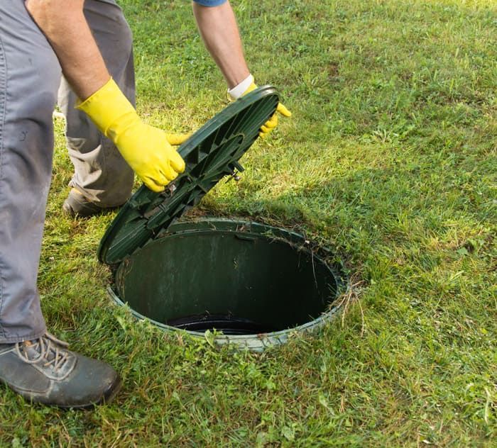 A professional is getting ready to clean a septic tank