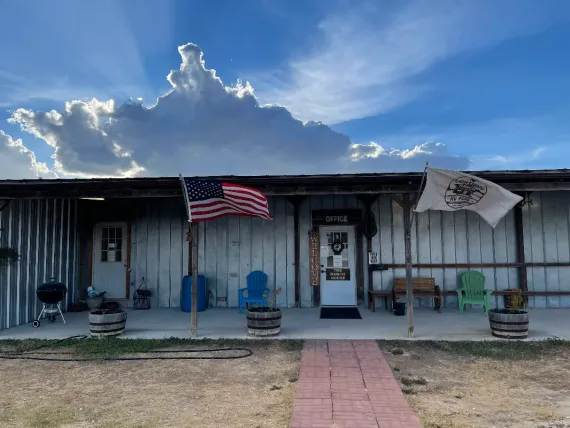 A house with a porch and two flags on it