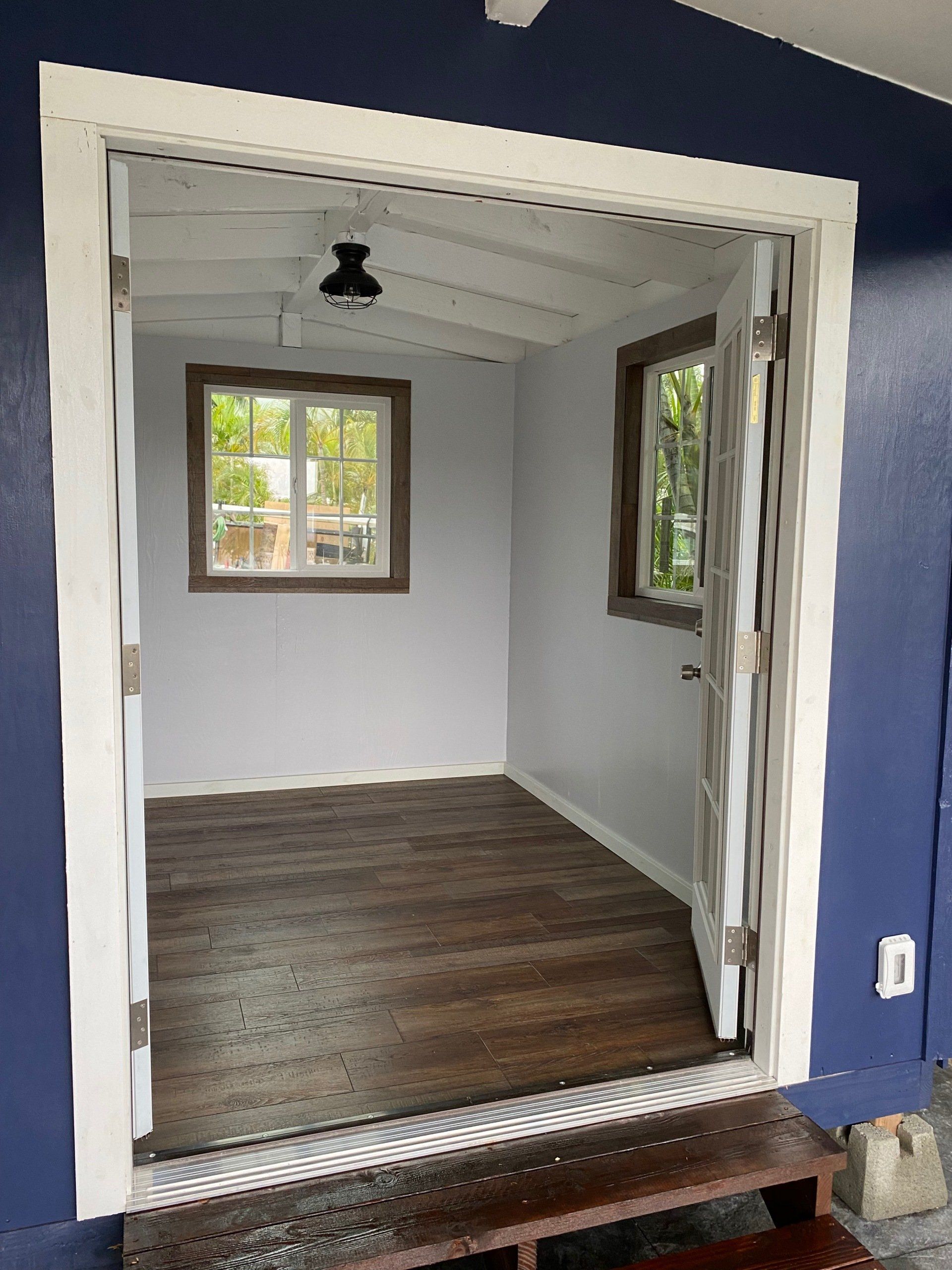 Studio Shed interior with flooring and lighting