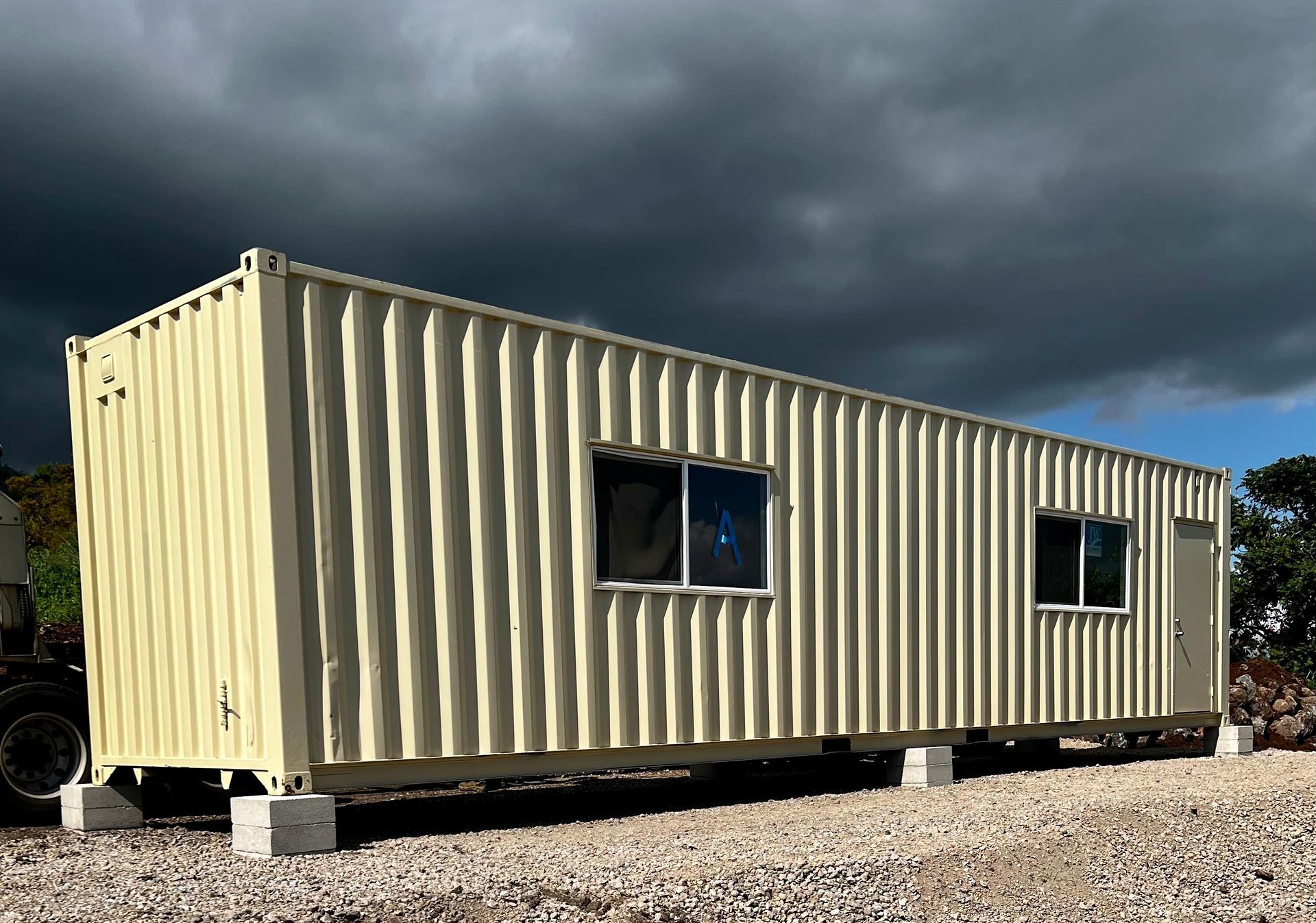 External view of 40' cargo container office with windows and siding