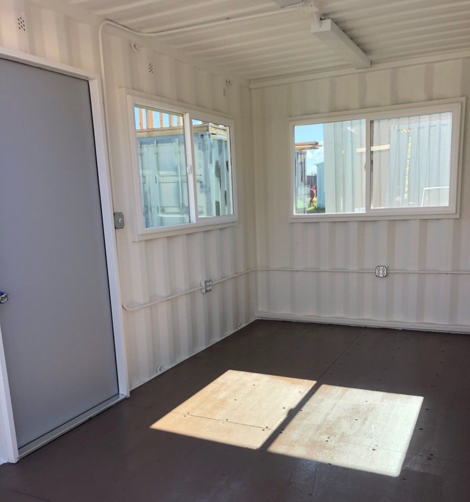 Interior windows of a shipping container office space.