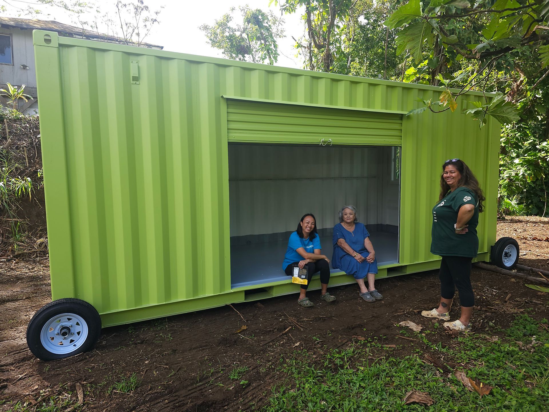 Papahana Kualoa volunteer members sitting in their modified containers.