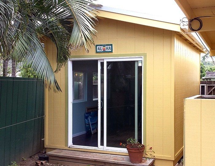 Studio shed with custom roof and sliding glass doors