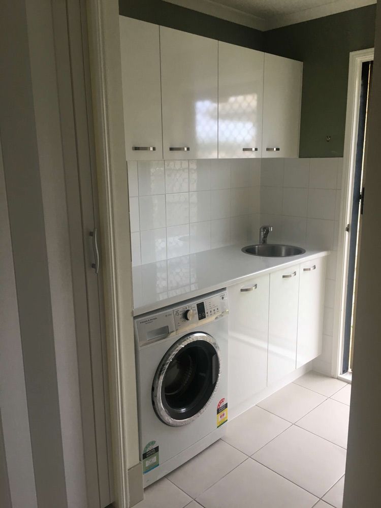 A Laundry Room With a Washer and Dryer and a Sink — GC Joinery in Sunshine Acres, QLD