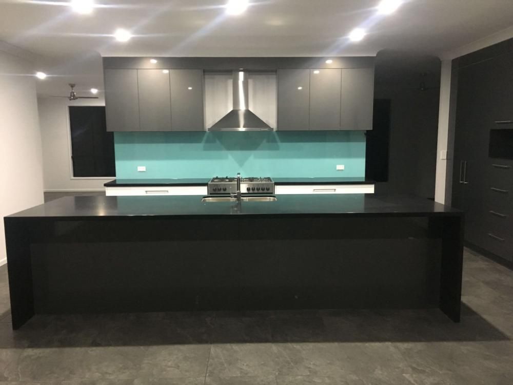 A Kitchen With a Large Island and a Stove Top Oven — GC Joinery in Sunshine Acres, QLD