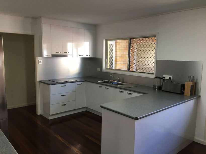 A Kitchen With White Cabinets, a Sink, a Toaster Oven, and a Window — GC Joinery in Sunshine Acres, QLD