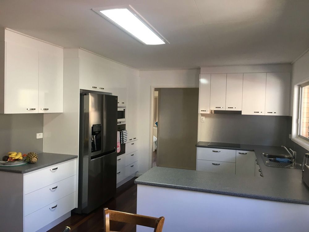 A Kitchen With White Cabinets and a Stainless Steel Refrigerator — GC Joinery in Sunshine Acres, QLD