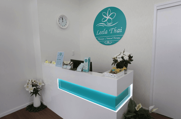 A Reception Desk in a Room With Flowers and a Clock on the Wall — GC Joinery in Sunshine Acres, QLD