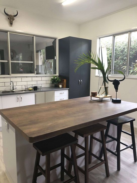 A Kitchen With a Large Wooden Table and Stools — GC Joinery in Sunshine Acres, QLD