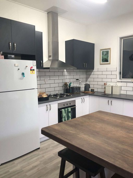 A Kitchen With a White Refrigerator and a Wooden Table — GC Joinery in Sunshine Acres, QLD