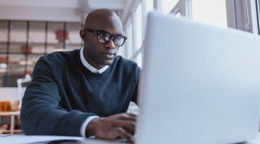 Young Man Using Online Resources — Online financial resources from Chicago, IL