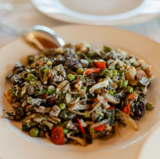 Un primer plano de un plato de comida con una cuchara dentro.