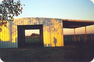 A shadow of a person is cast on the side of a building