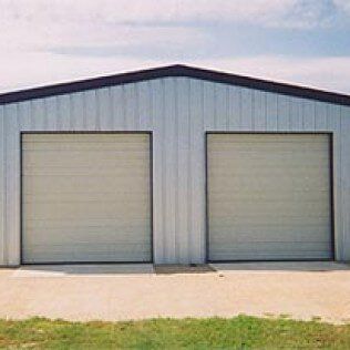 A metal garage with two garage doors on a sunny day.