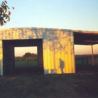 A shadow of a person is cast on the side of a building.