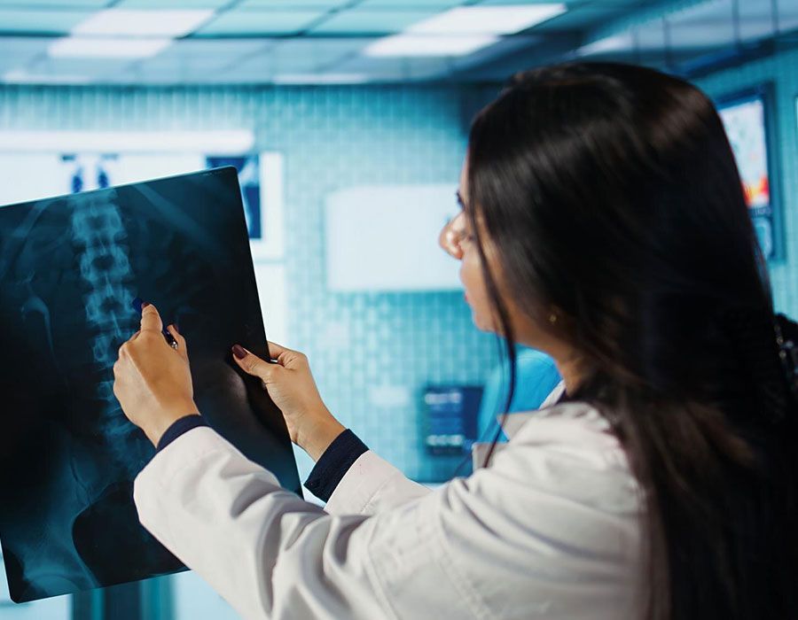 Doctor examining an X-ray in a hospital setting