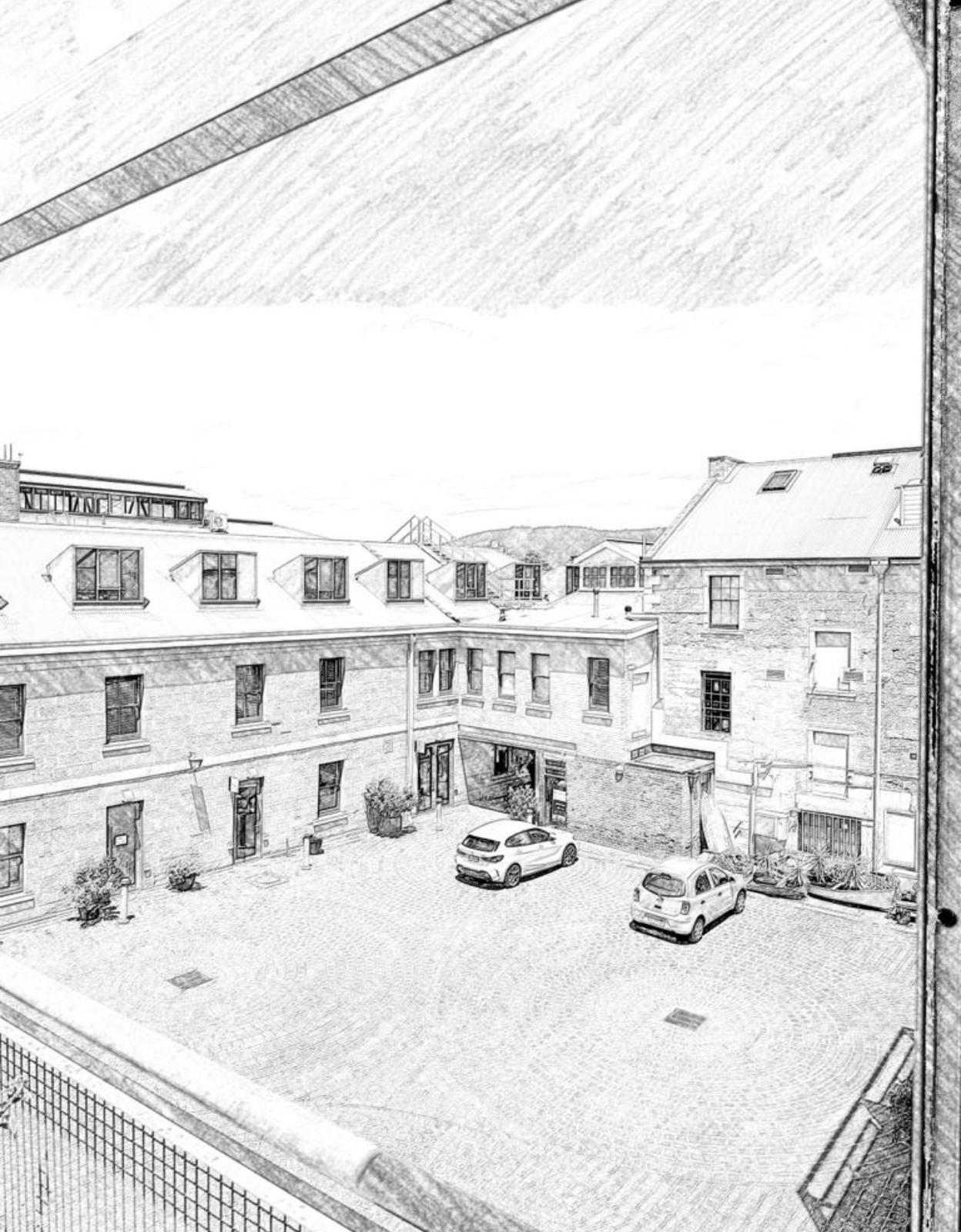 A black and white drawing of a parking lot with cars parked in front of a building.