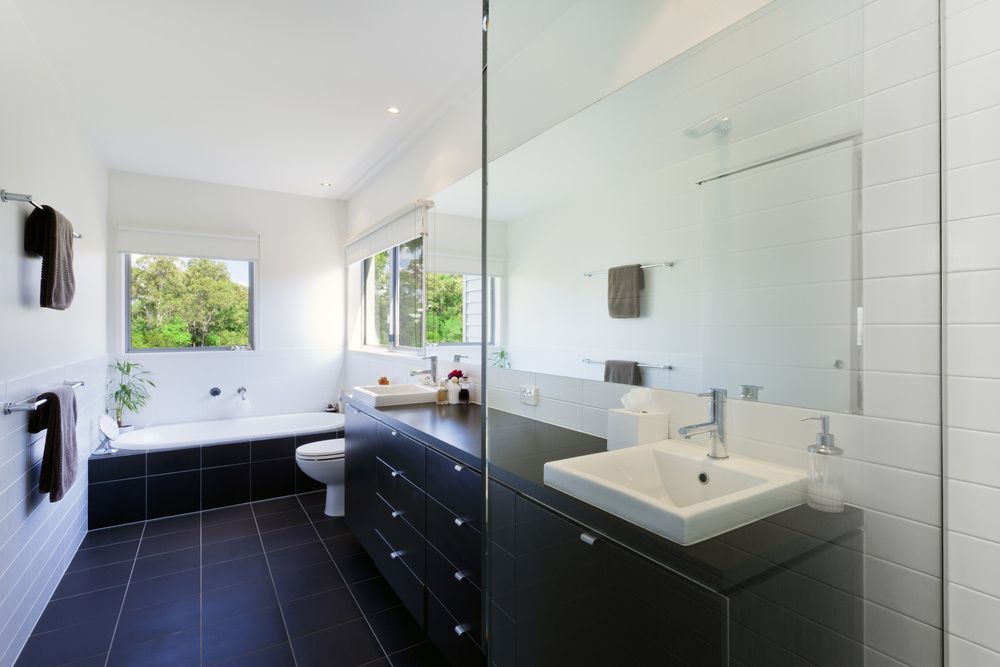 A Bathroom With a Sink, Toilet and Bathtub — Glen Lamberts Wall Cladding & Home Improvements in Taree, NSW