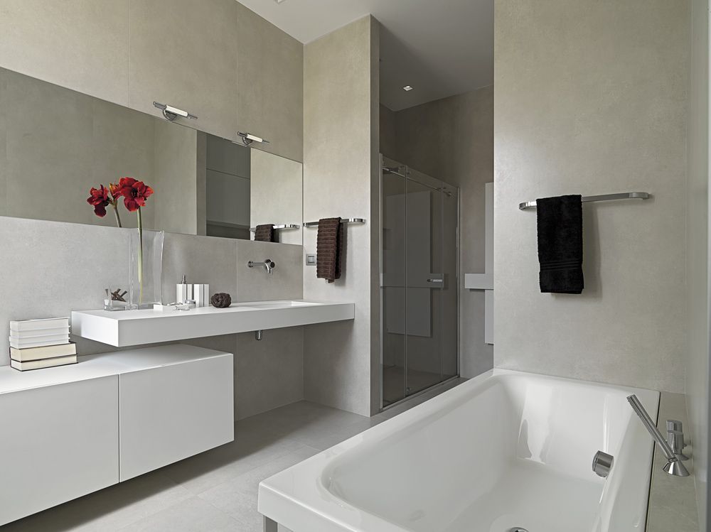 A Bathroom with A Bathtub a Sink and A Mirror — Glen Lamberts Wall Cladding & Home Improvements in Wingham, NSW