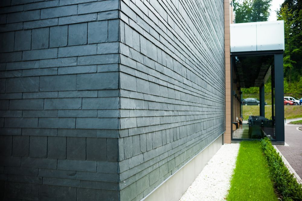 The Side of a Building With a Lot of Bricks on It — Glen Lamberts Wall Cladding & Home Improvements in Smiths Lake, NSW
