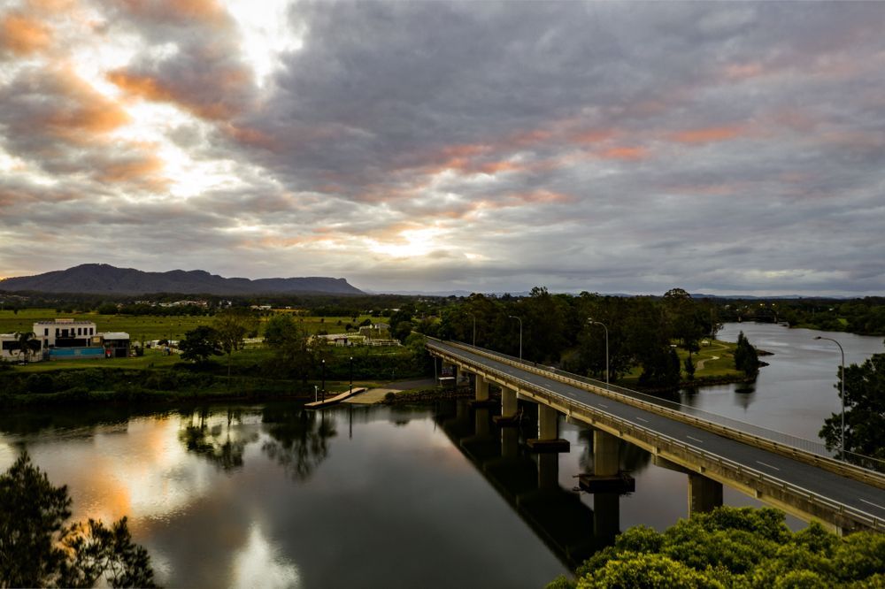 An Aerial View of a Bridge Over a River at Sunset — Glen Lamberts Wall Cladding & Home Improvements in Wauchope, NSW