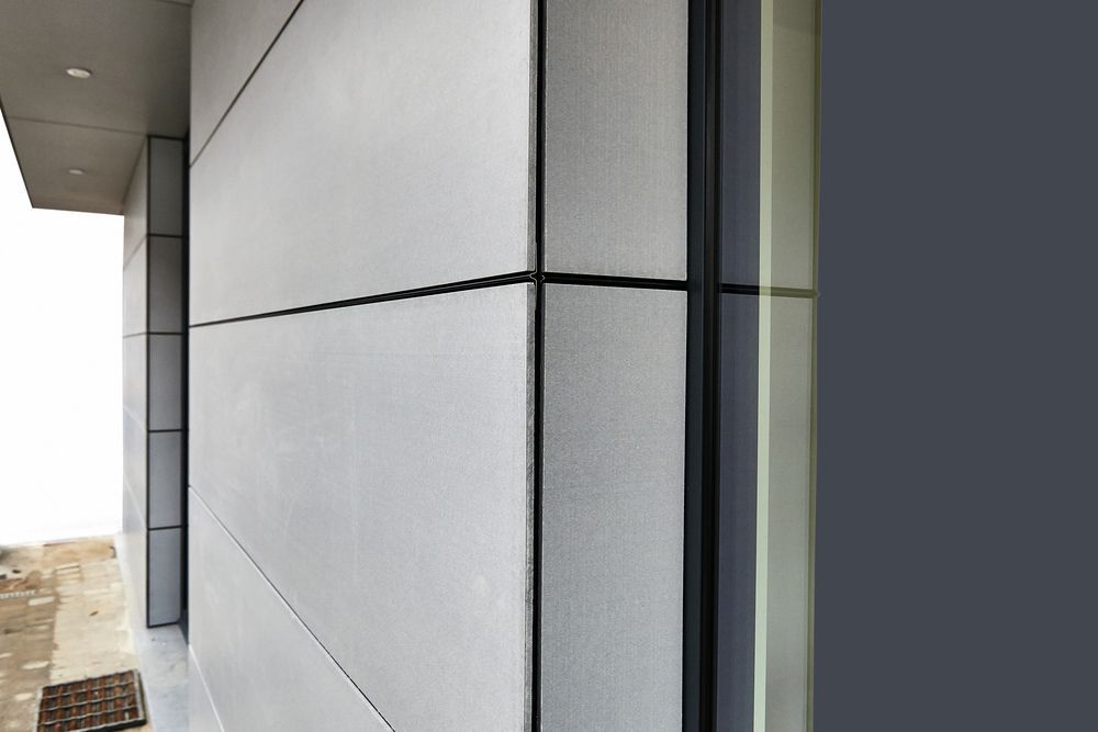 A Close Up of a Building With a Gray Wall and a Window — Glen Lamberts Wall Cladding & Home Improvements in Forster, NSW