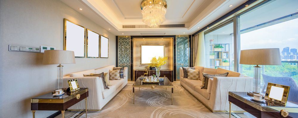 A Living Room With a Lot of Furniture and a Chandelier — Glen Lamberts Wall Cladding & Home Improvements in Taree, NSW