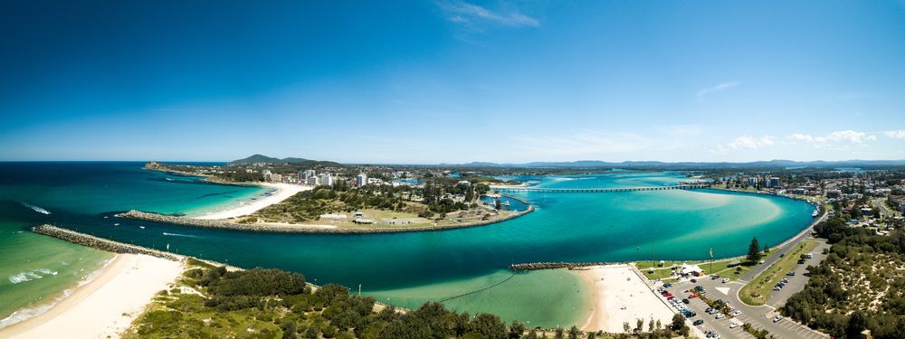 An Aerial View of a Body of Water With a City in the Background — Glen Lamberts Wall Cladding & Home Improvements in Tuncurry, NSW