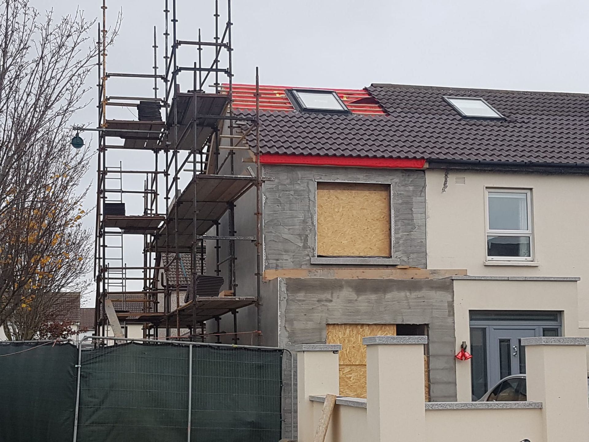 A house under construction with scaffolding on the side of it