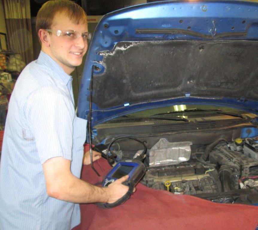 mechanic repairing car after towing services in Gillett, WI