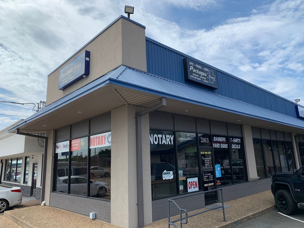 A building with a blue roof and a sign that says ' notary ' on it.