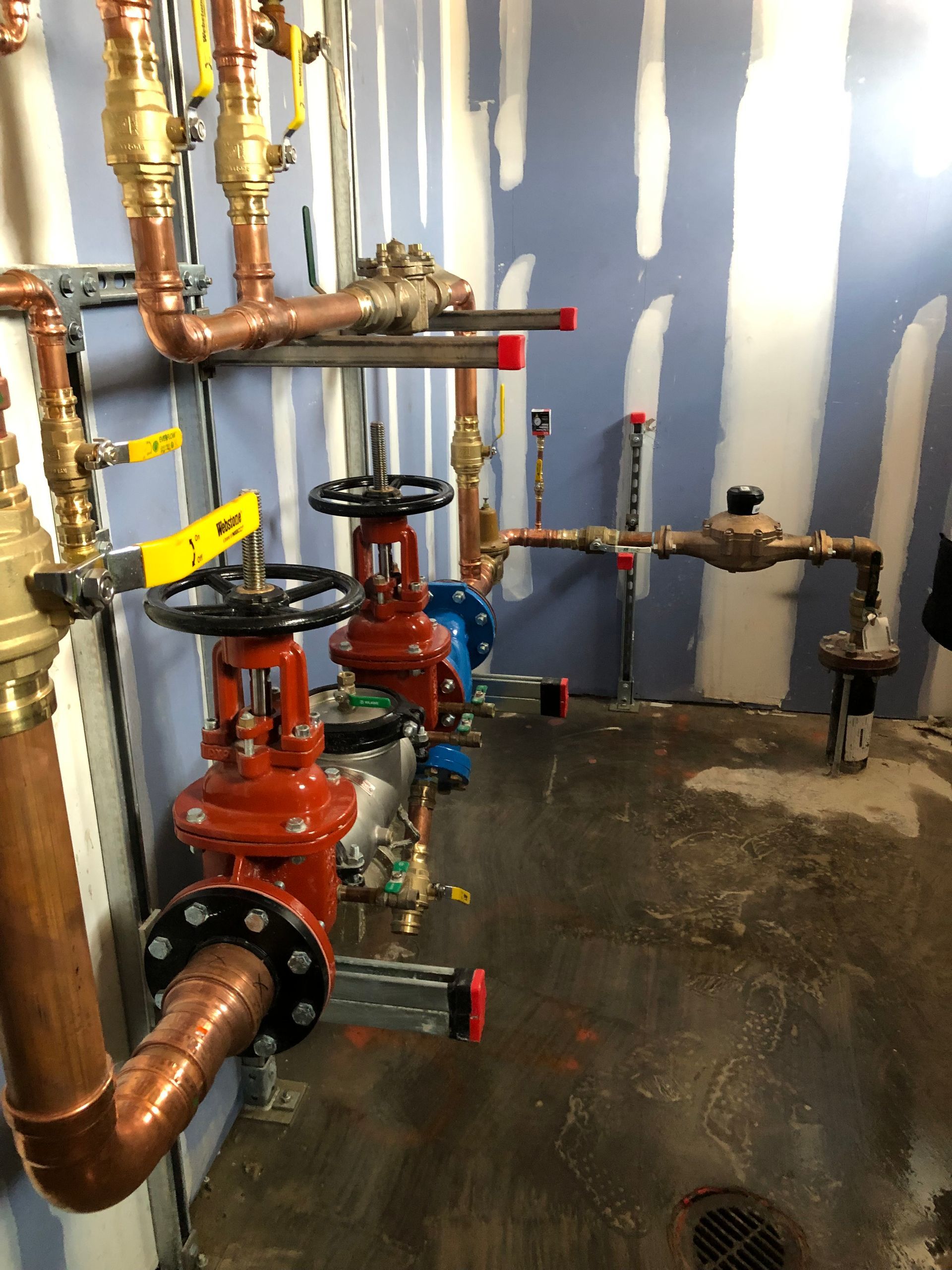 Two chefs in a commercial kitchen preparing food. One cooks on a stove, the other chops vegetables.