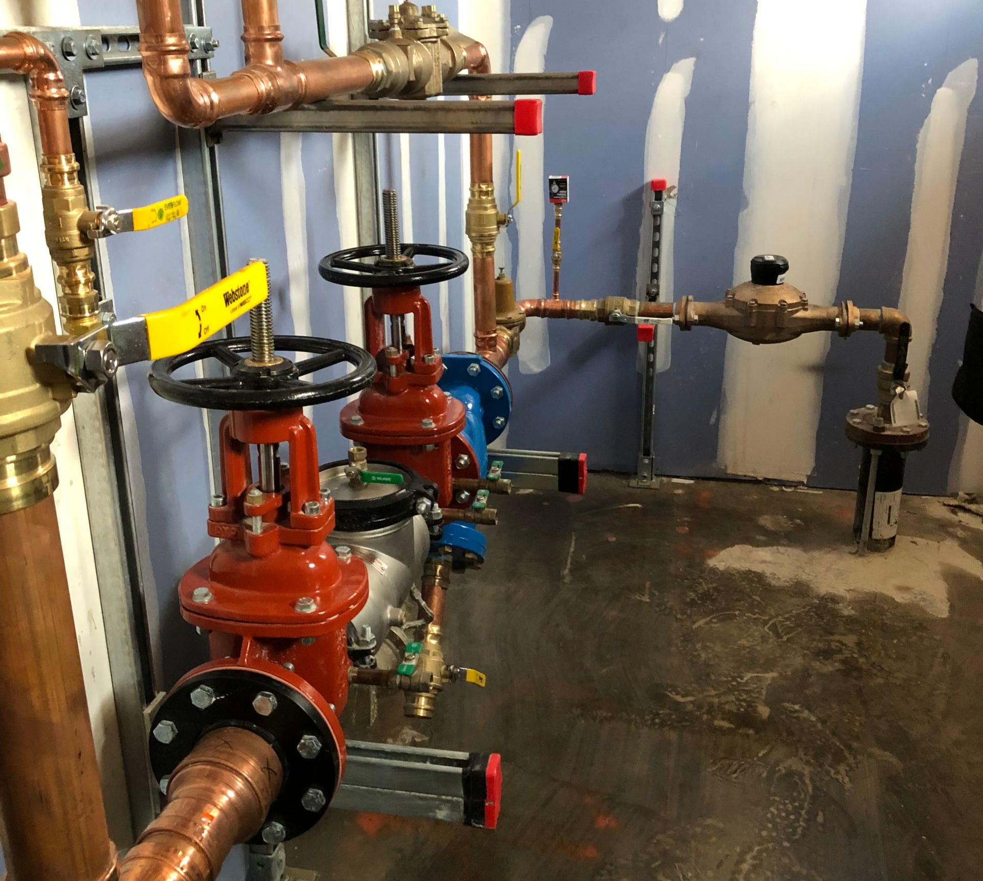 Construction site with foundation framework, heavy machinery, and workers.