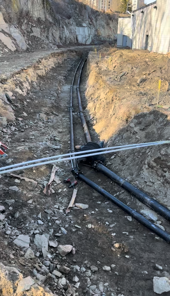 Person in blue gloves using a plunger in a sink full of yellow liquid.