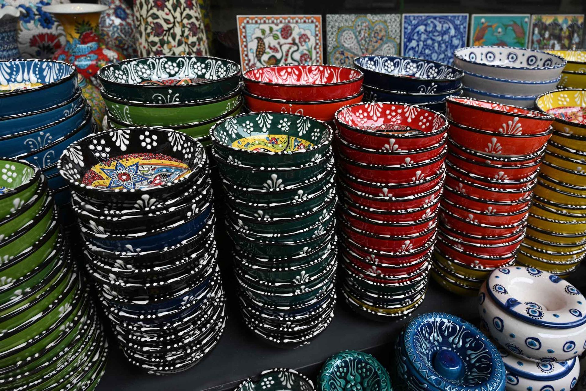 Many colorful bowls are stacked on top of each other