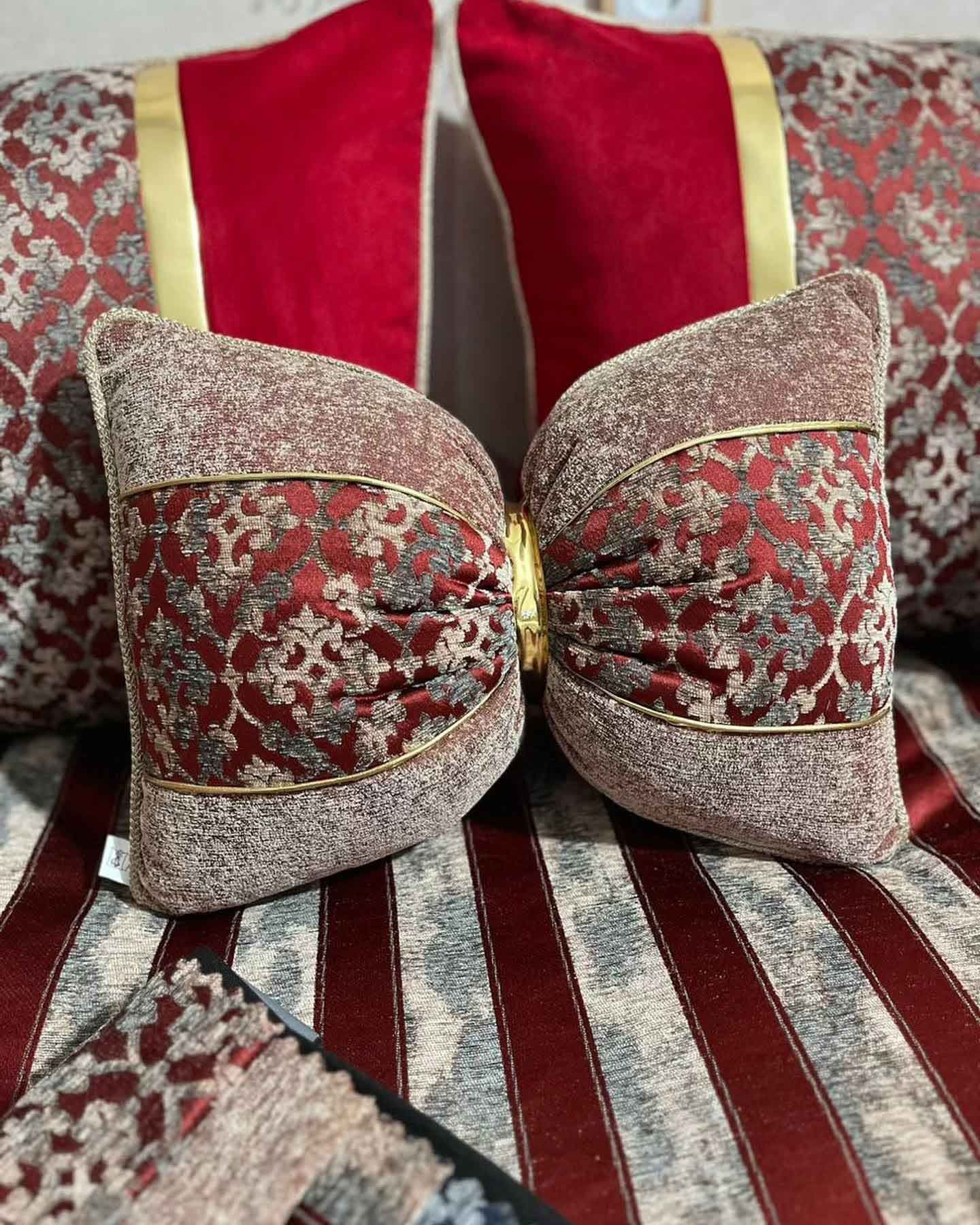 A couple of pillows sitting on top of a couch.