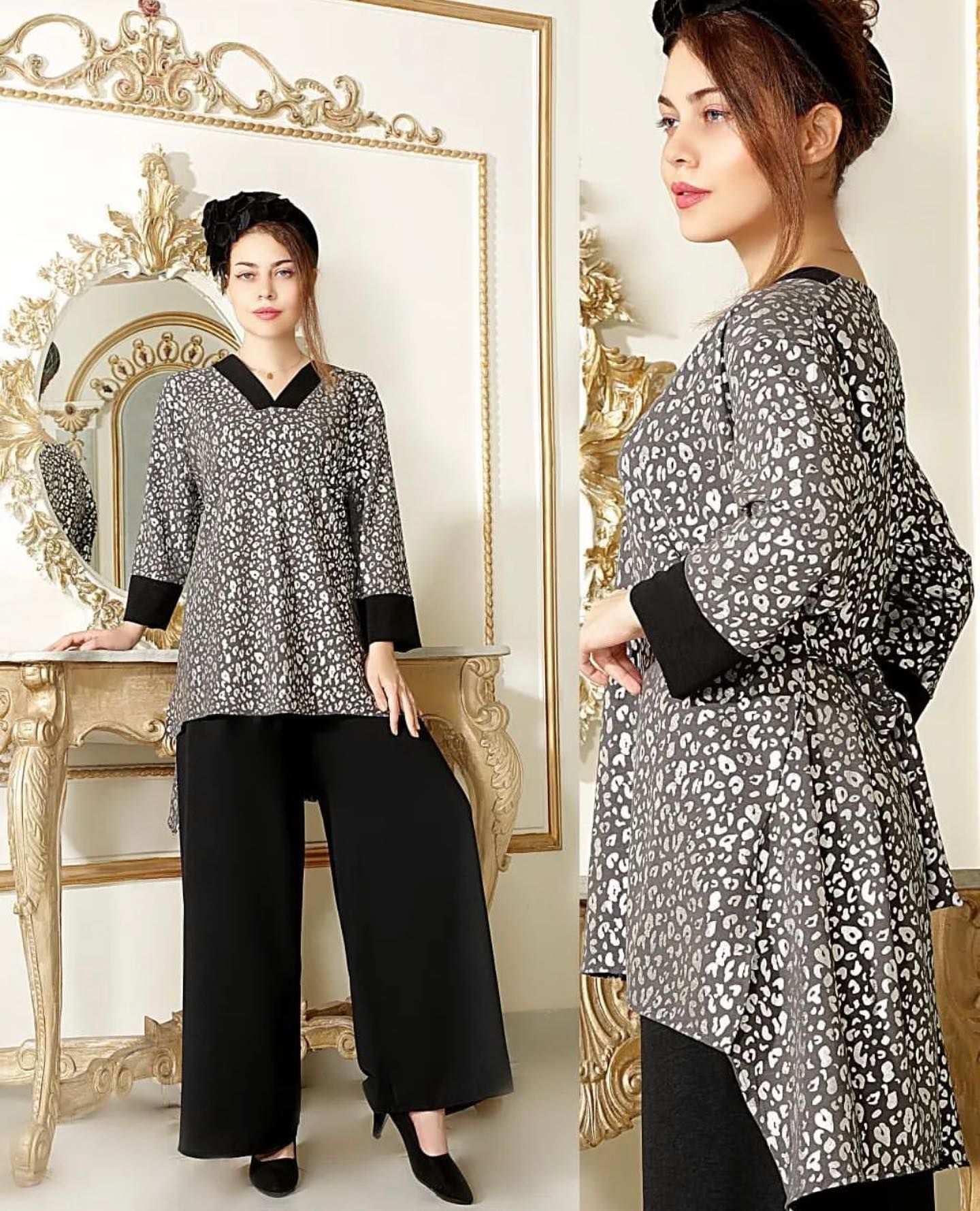 A woman in a leopard print top and black pants is standing in front of a mirror.