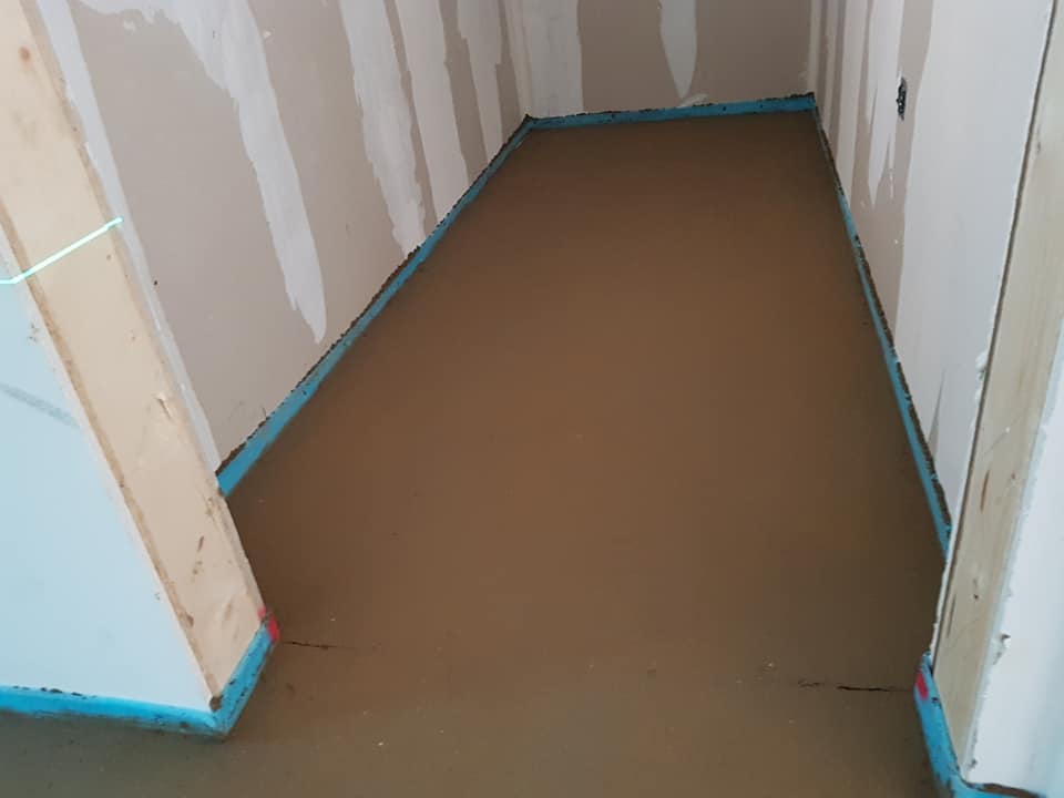 a corner of a room with a concrete floor in it .