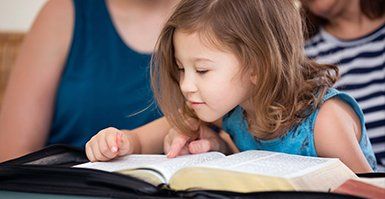 Sunday Worship — Child Reading Bible in Hoquiam, WA