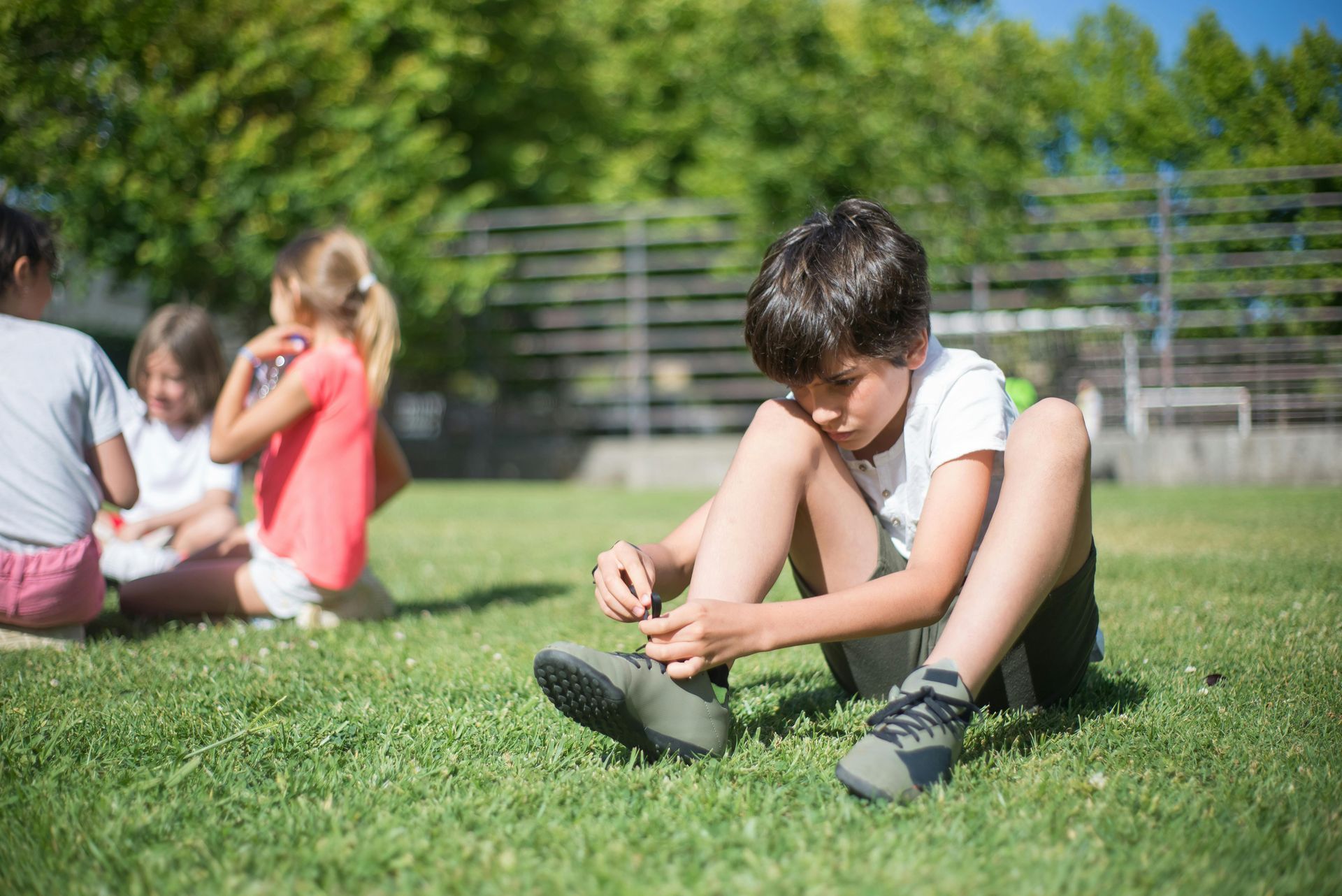 child practicing tying his shoes