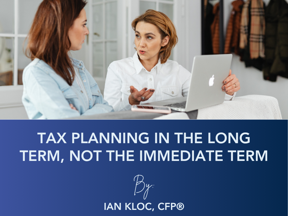 Two people sit at a table with a laptop. Text reads: 