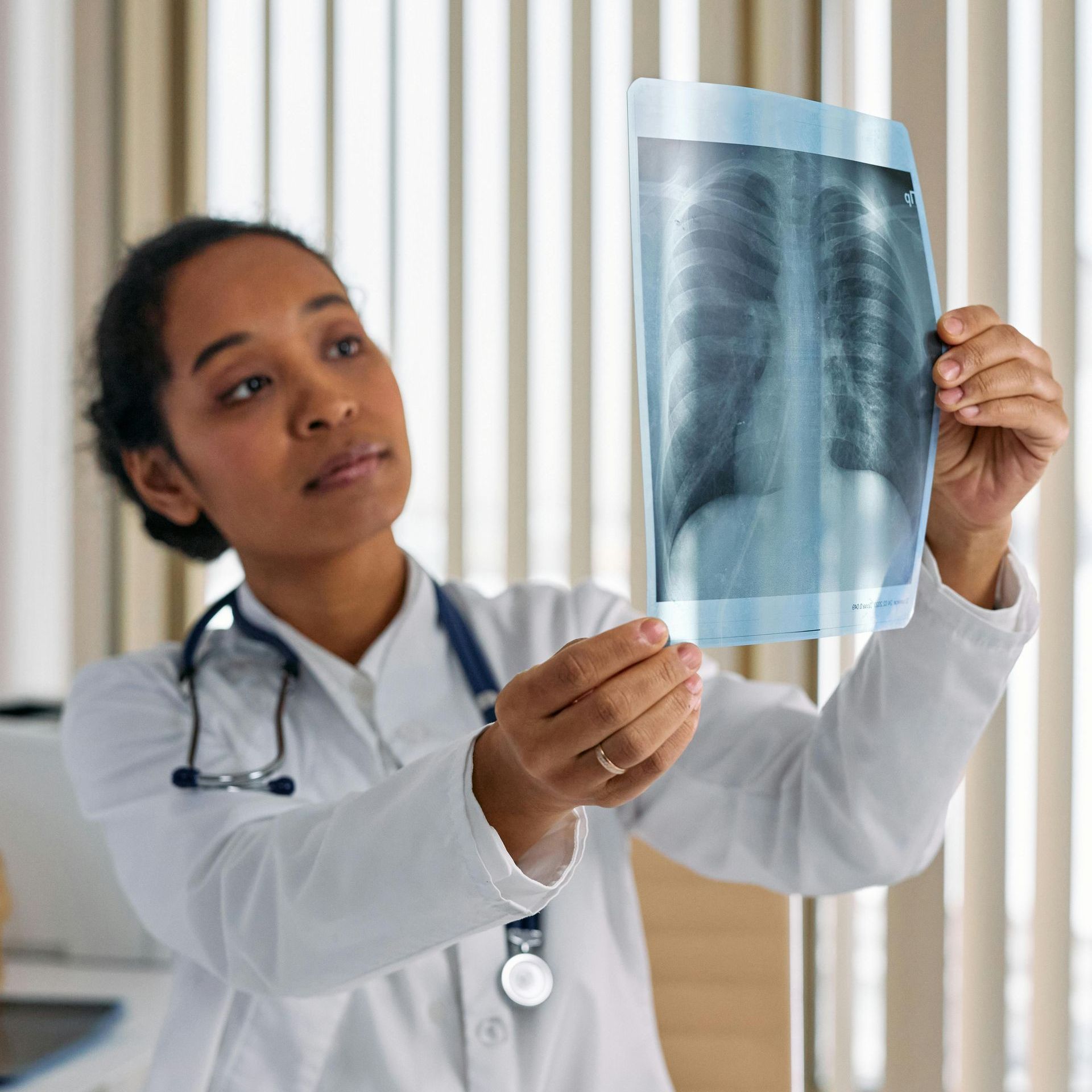 stock photo of a medical professional looking at an xray scan