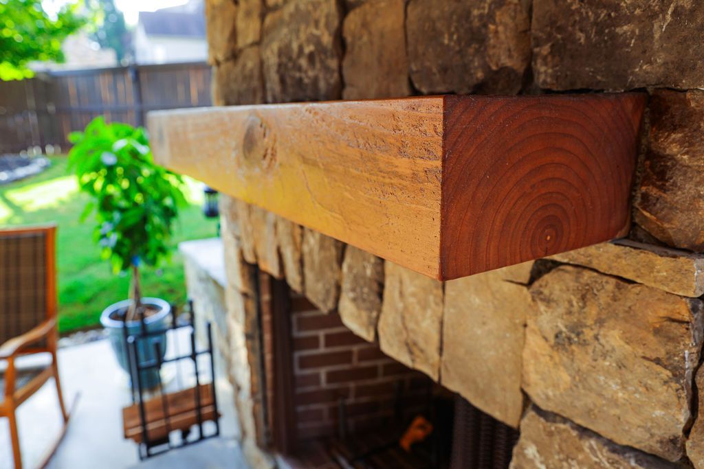Outdoor stone fireplace with mantle. 