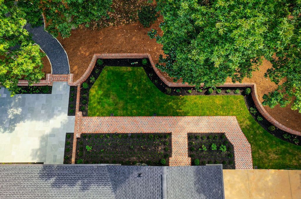 Ariel view of brick walkway, brick retaining wall and antique limestone patio.