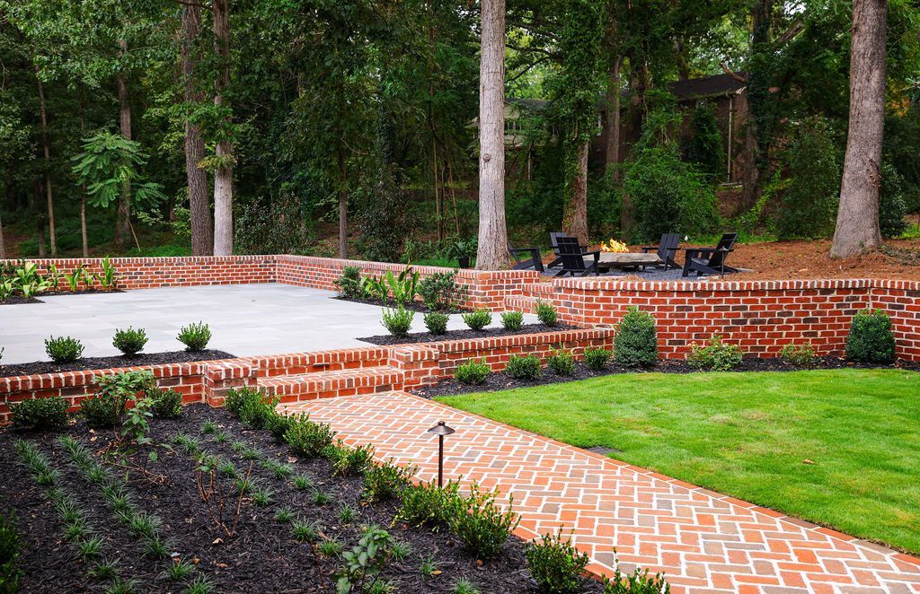 Herringbone brick walkway with Antique Limestone Patio and landscaping.