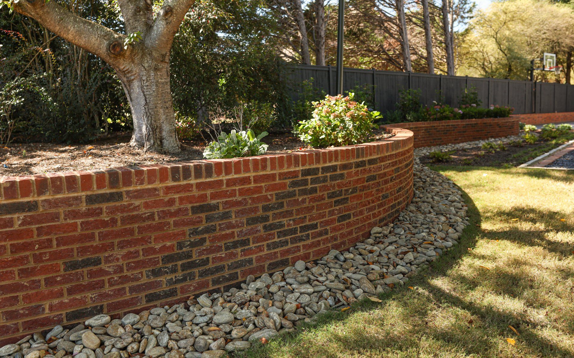 Curved brick retaining wall with row lock detail.