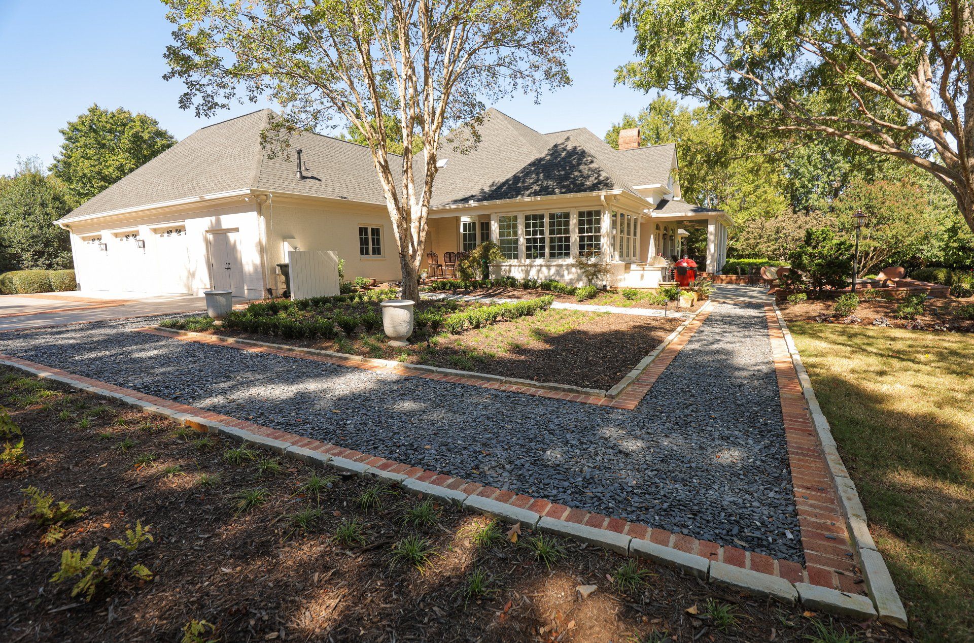 Garden walkway with flagstone coble, brick row lock and mini slate chip.