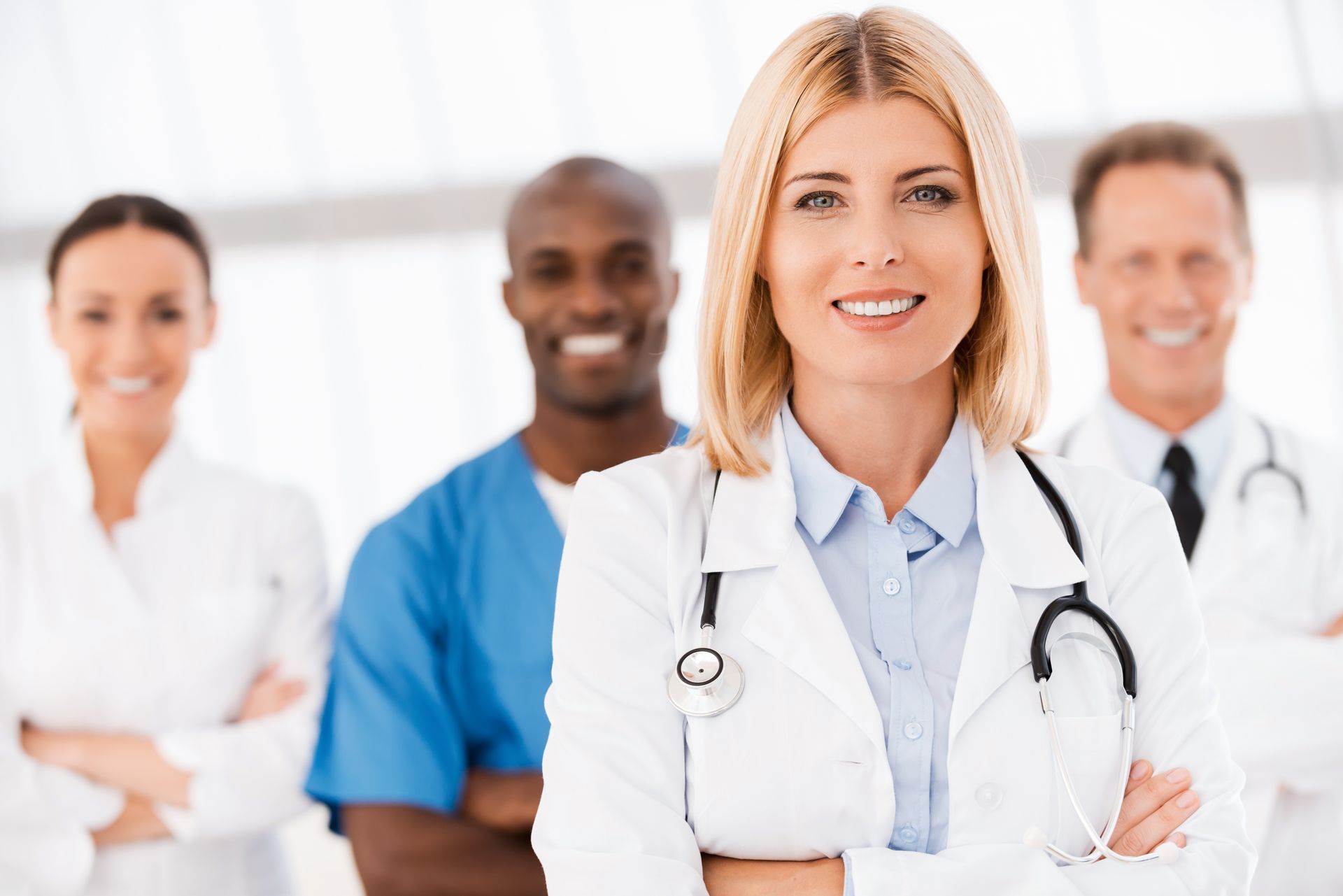 A group of doctors and nurses are posing for a picture.