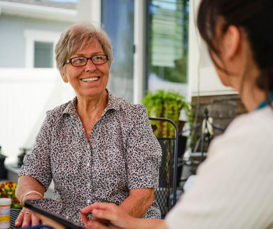 A medical provider is talking with a smiling patient